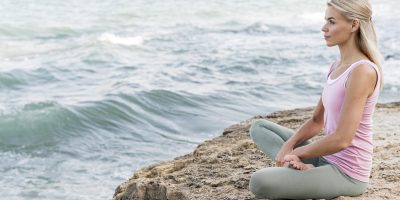 beautiful-blonde-woman-doing-yoga-beach