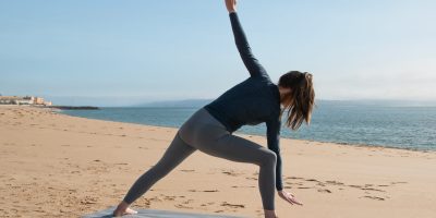 young-woman-practicing-yoga-beach-concept-healthy-lifestyle-relaxation